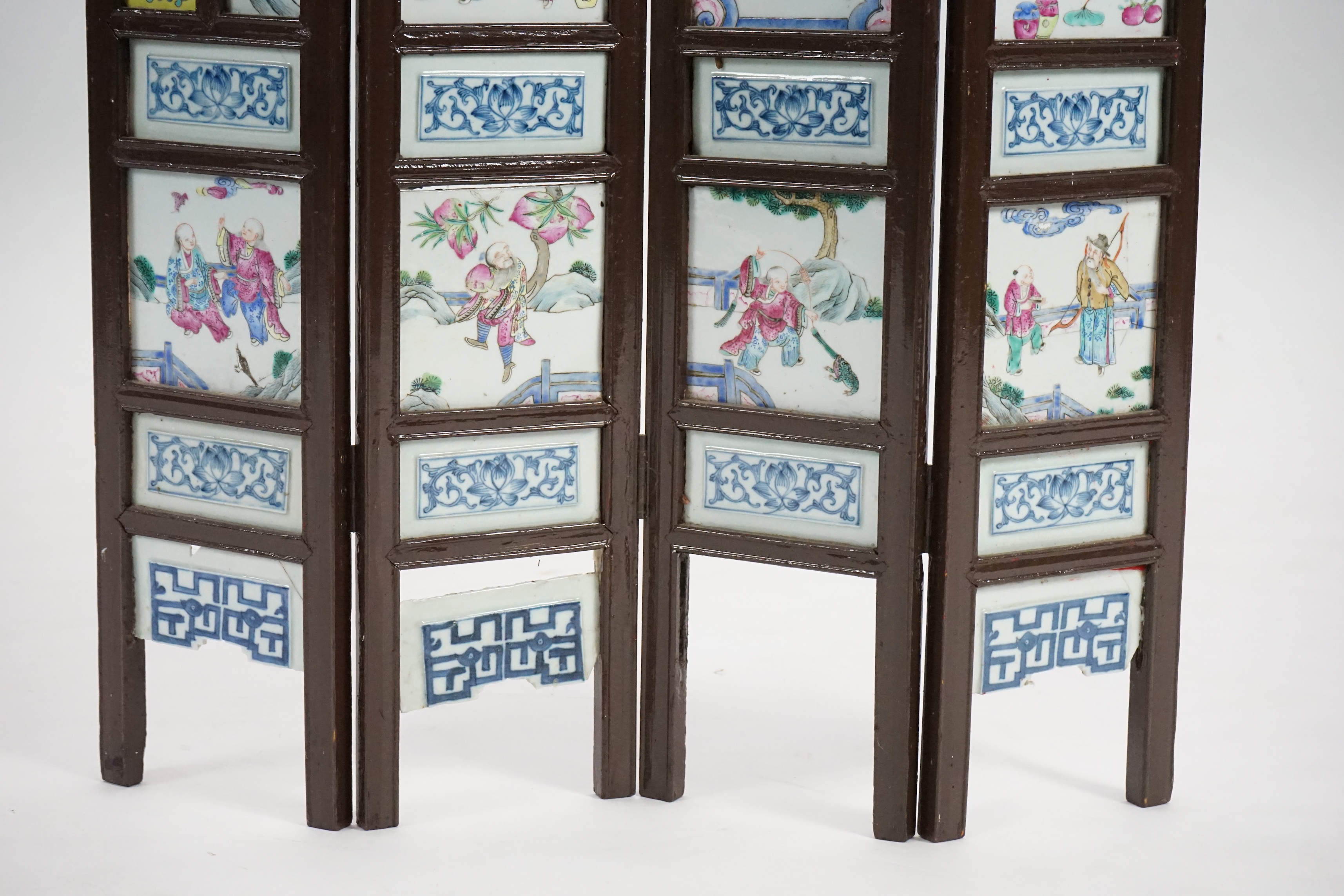 A Chinese wood framed and porcelain mounted low screen, late 19th century